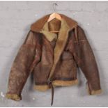 A vintage leather flight jacket with sheep skin liner. (small size). No rips or tears. Wear to