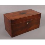 A Regency mahogany tea caddy with fitted interior. Compartment lids with damage.