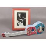 A Selco Tommy Steele plastic guitar, along with a framed autographed photograph.