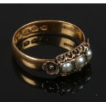 A Victorian 22ct gold ring, set with 3 pearls, size N. 2.80g gross weight.