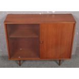 A teak side cabinet with sliding doors. (91cm x 75cm x 30cm)