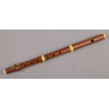 A 19th century boxwood and ivory flute, stamped Metzler, London. (Length 35cm).