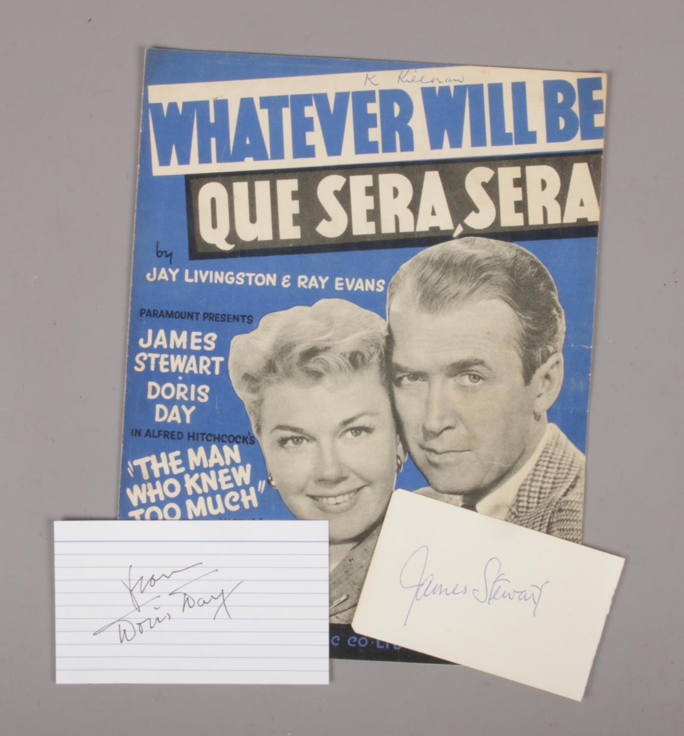 Doris Day and James Stewart autographed pages, along with a Whatever Will Be Que Sera, Sera music