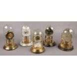 Five brass torsion clocks mostly with glass domes to include Schats etc.