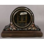A dome top painted mantel clock with mother of pearl inlay and open movement.