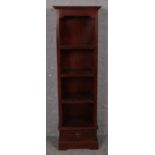 A mahogany slender bookcase with drawer base. (180cm x 55cm)