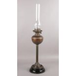 A brass oil lamp with glass shade
