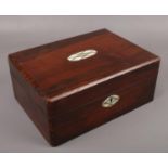 A Victorian rosewood vanity box with mirrored and fitted interior.
