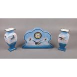 A c1920 Staffordshire ceramic clock garniture in blue, printed with birds.