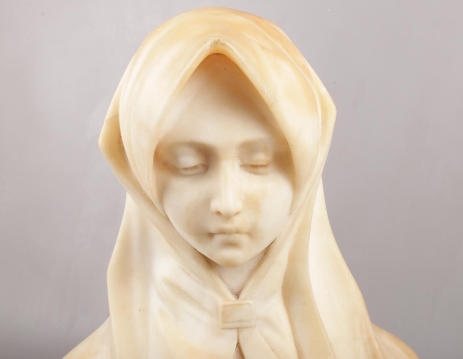 An alabaster bust of the Virgin Mary, raised on wooden plinth. (Total height 38cm). - Image 2 of 3