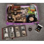 A box of collectables to include trophies, Swarovski clip on earrings, vintage photo album with