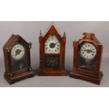 Three American alarm clocks to include carved floral example etc.