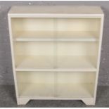A white painted glass sliding door bookcase.