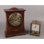 An inlaid oak mantel clock movement stamped PHS along with a German Shcats glass torsion clock. No