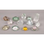 A collection of glass paper weights to include, small glass paper weight with yellow flower, a