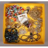A collection of costume jewellery necklaces, to include gilt metal examples, beads, aurora