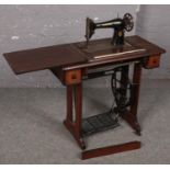A oak treadle Singer sewing machine.