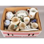 A box of miscellaneous to include graduated ceramic jugs, Wedgwood tankards, horse brasses, etc.