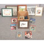 A box of commemorative books along with a collection framed paintings and prints to include framed
