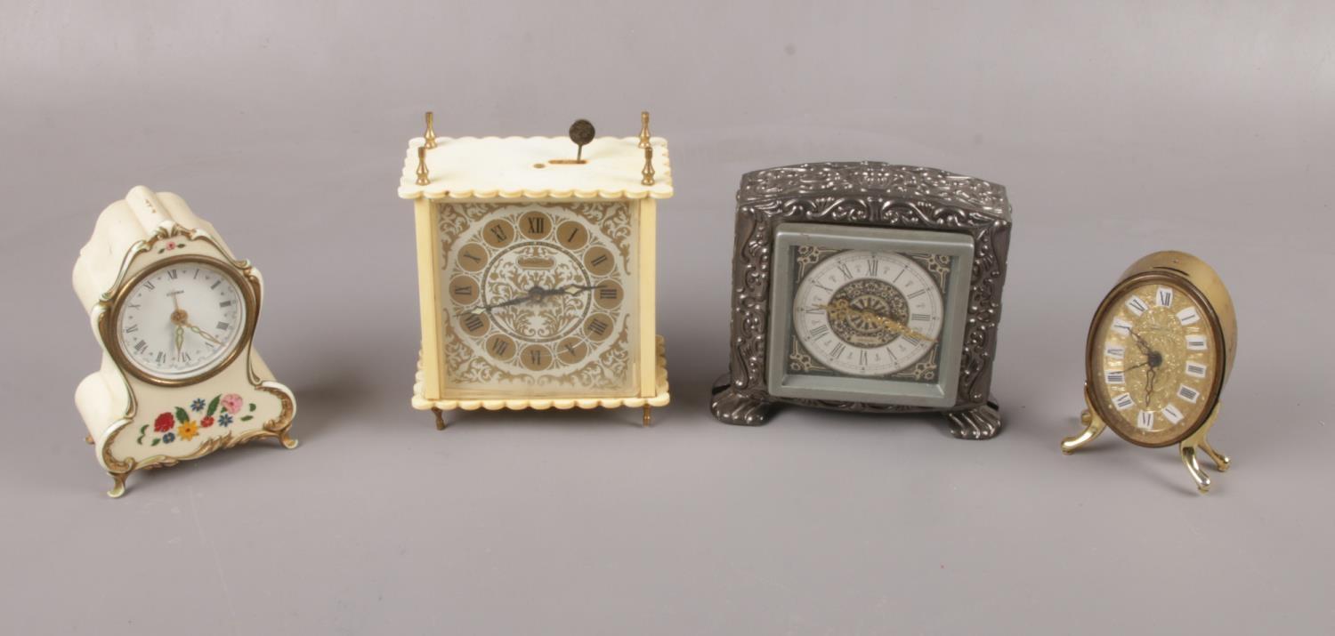 Four plastic and metal alarm clocks to include, "Estyma" cream clock decorated with multi coloured