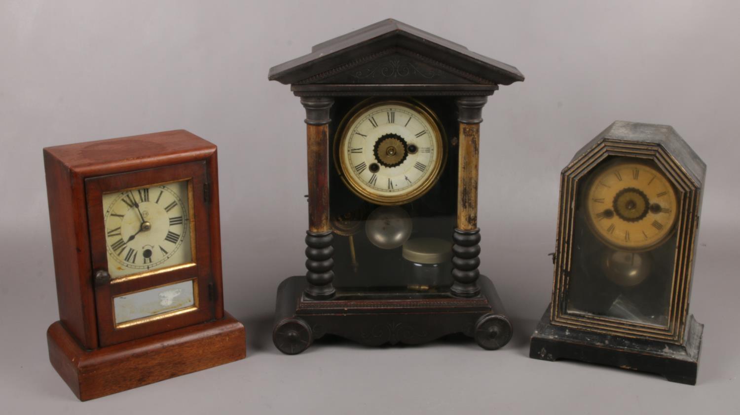 Two American alarm clocks along with a mahogany cased mantel clock.