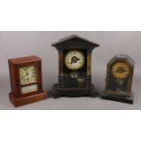 Two American alarm clocks along with a mahogany cased mantel clock.