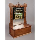 A carved oak hall mirror with glove box storage, and Peugeot advertising glass.