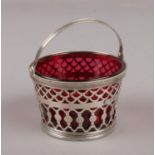 A French silver basket with red glass liner, control marks.