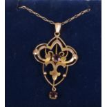 A 9ct gold art nouveau garnet pendant on 9ct gold trace chain. Gross weight 2.75g