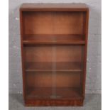 A mahogany bookcase with glass sliding doors. (66cm x 110cm x 28cm)