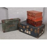 A vintage travel trunk, along with four vintage suitcases, to include W Heather example.