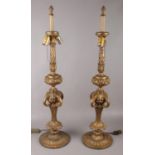 A pair of large gilt metal table lamps. (90cm tall) No damage. Light pull not working on one lamp.