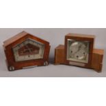 An art deco mahogany presentation mantel clock along with an art deco inlaid mahogany mantel clock.