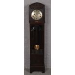 An early 20th century oak long case clock with silvered dial, stencilled J.C Bell Doncaster.