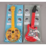 Two The Beatles plastic guitars, both in packaging, 41cm.