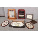 A box of glass and plastic trays to include, a pair of embroidered trays covered with glass, a