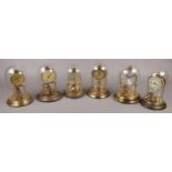 Six brass torsion clocks mostly with glass domes to include Kundo, Schats etc.