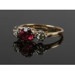 An 18ct gold diamond and pink sapphire three stone ring, size L 1/2. (3.26g)