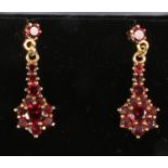A pair of silver gilt garnet pendant earrings.