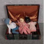 A vintage suitcase with contents of dolls, to include Roddy example.