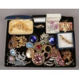 A collection of costume jewellery brooches, mainly paste set examples. four missing paste stones.