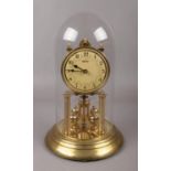 A Violeta brass torsion clock under glass dome. (height 32cm).