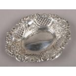 A silver oval dish with lattice pierced sides and repousse decoration, assayed Sheffield 1914. (