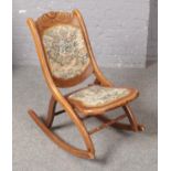 An Early 20th Century carved folding Rocking chair