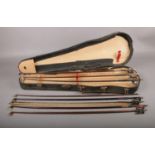A Violin case together with eight bows. The Violin case has two broken clasps.
