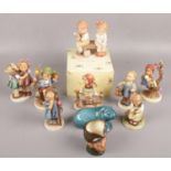 A quantity of mostly Goebel hummel figures to include boy carrying shoes, figures sat on branches,