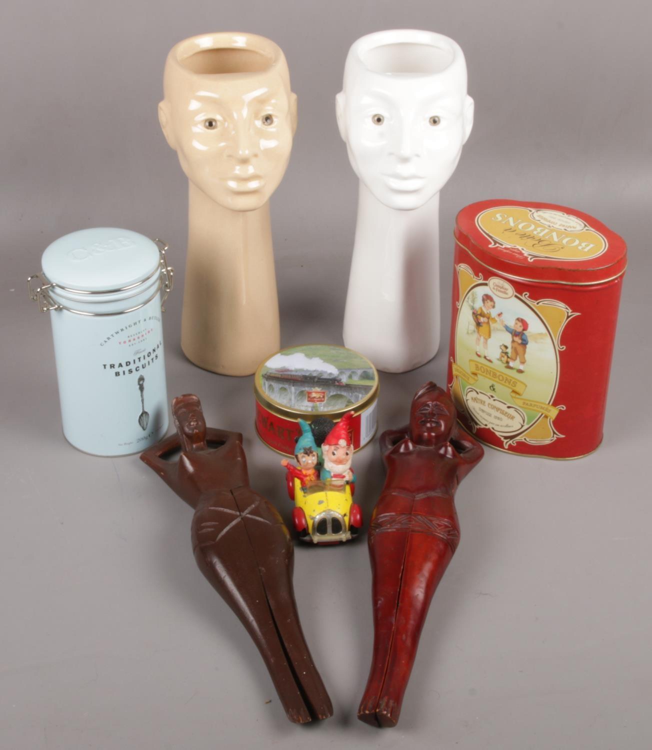 A group of a collectables to include ceramic face vases, wooden novelty nut crackers, Corgi Noddy'