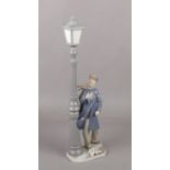 A Large Lladro figure of man and a street lamp, 47cm height Fingers and thumb missing on left