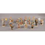 A collection of Goebel ceramic figures, Waiter Hum 154, The Artist Hum 304, Little Pharmacist Hum