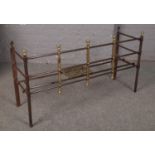 An early 19th century steel and brass fire fender with sliding pierced brass trivet, measuring -